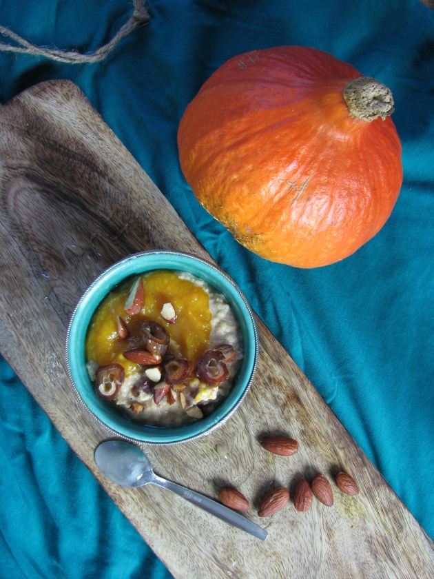 Pumpkin spice breakfast millet porridge with roasted almonds and dates